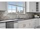 Close-up of a kitchen sink area featuring modern fixtures and tiled backsplash at 11522 Trona Ct, Parker, CO 80138