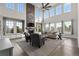 Spacious living room with soaring ceilings, a cozy stone fireplace, and lots of natural light at 11522 Trona Ct, Parker, CO 80138