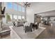 Open concept living room with soaring ceilings, a cozy stone fireplace, and view of the dining area at 11522 Trona Ct, Parker, CO 80138