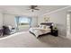 Bright and airy main bedroom featuring plush carpet, large windows, and a cozy sitting area at 11522 Trona Ct, Parker, CO 80138