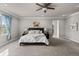 Spacious main bedroom with a ceiling fan, plush carpet, and natural light from a large window at 11522 Trona Ct, Parker, CO 80138