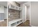 Mudroom with wood accent wall and a built-in bench with storage underneath at 11522 Trona Ct, Parker, CO 80138
