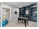 Well-lit office with custom built-ins, a comfortable chair, and a functional desk at 11522 Trona Ct, Parker, CO 80138