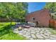 Charming backyard patio with stone pavers, comfortable seating, and a brick facade at 1278 Dexter St, Denver, CO 80220