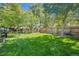 Beautifully landscaped backyard with lush green grass, a wooden fence, and mature trees at 1278 Dexter St, Denver, CO 80220