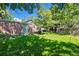 Scenic backyard showing a green lawn, mature trees, and a cozy outdoor seating area at 1278 Dexter St, Denver, CO 80220