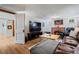 A cozy basement rec room features a brick fireplace, television, and plush leather sectional at 1278 Dexter St, Denver, CO 80220