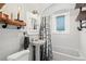 Stylish bathroom with white tiles, unique fixtures, and a shower-tub combination for a refreshing experience at 1278 Dexter St, Denver, CO 80220