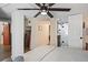 Bright bedroom featuring a ceiling fan, and ensuite bathroom with a sliding barn door at 1278 Dexter St, Denver, CO 80220