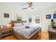 Comfortable bedroom featuring hardwood floors, a ceiling fan, and a well-lit space with a cozy bed and side tables at 1278 Dexter St, Denver, CO 80220
