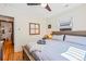 Bright bedroom with hardwood floors, a comfortable bed, soft lighting, and a view of the outdoors through a large window at 1278 Dexter St, Denver, CO 80220