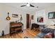 Cozy bedroom featuring hardwood floors, a classic piano, and a comfortable seating area with a plush sofa at 1278 Dexter St, Denver, CO 80220