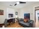 Inviting bedroom with hardwood floors, a modern desk setup, and a comfortable seating area with a tufted sofa at 1278 Dexter St, Denver, CO 80220