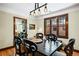 Charming dining room featuring hardwood floors, a modern light fixture, and dark wood window frames and furniture at 1278 Dexter St, Denver, CO 80220