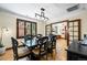 Elegant dining room with dark wood table and chairs, hardwood floors, and chandelier lighting at 1278 Dexter St, Denver, CO 80220
