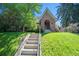 Charming brick home with a landscaped front yard and steps leading to the front door at 1278 Dexter St, Denver, CO 80220