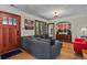 Cozy living room with hardwood floors, a grey sofa, and a wooden door at 1278 Dexter St, Denver, CO 80220