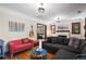 Spacious living room with a guitar on the wall, plush sofas, and hardwood floors at 1278 Dexter St, Denver, CO 80220