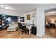 A bright home office boasts a white desk, filing cabinet, and comfortable reading nook at 1278 Dexter St, Denver, CO 80220