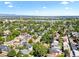 Picturesque aerial view of the neighborhood, showcasing mature trees, a lake, and the city skyline at 4429 Winona Ct, Denver, CO 80212