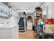 Basement laundry room with a washer, dryer, shelving, and convenient access to the staircase at 4429 Winona Ct, Denver, CO 80212