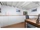 Finished basement area with exposed beams, updated lighting, and windows bringing in natural light at 4429 Winona Ct, Denver, CO 80212