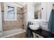 Bathroom with a shower and tub combination, and a modern vessel sink on a black counter at 4429 Winona Ct, Denver, CO 80212