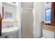 Bright bathroom featuring a walk-in shower, white vanity sink, and a charming window with natural light at 4429 Winona Ct, Denver, CO 80212