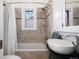 Bathroom featuring tiled walls, a bathtub with shower, and a modern vessel sink at 4429 Winona Ct, Denver, CO 80212