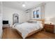 Cozy bedroom featuring hardwood floors, a large window with curtains, and natural light at 4429 Winona Ct, Denver, CO 80212