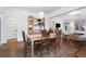 Traditional dining room featuring hardwood floors, built-in shelving, and access to other living spaces at 4429 Winona Ct, Denver, CO 80212