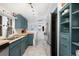 Contemporary kitchen with stainless steel refrigerator, updated lighting, and blue cabinets at 4429 Winona Ct, Denver, CO 80212