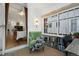 Bright sunroom featuring large windows, a cozy chair, and a view into an adjacent bedroom at 4429 Winona Ct, Denver, CO 80212