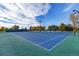 Well-maintained outdoor tennis courts with a vibrant blue surface and nets at 4429 Winona Ct, Denver, CO 80212