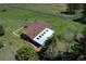 Bird's-eye view of the home with a unique roof design, surrounded by greenery and a winding driveway at 1971 Kerr Gulch Rd, Evergreen, CO 80439