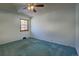 A simple bedroom with a ceiling fan and window for natural light at 1971 Kerr Gulch Rd, Evergreen, CO 80439