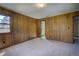 Spacious bedroom with wood paneled walls and neutral carpet at 1971 Kerr Gulch Rd, Evergreen, CO 80439