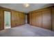 Bedroom featuring wood panel walls, carpet floors, and a large closet at 1971 Kerr Gulch Rd, Evergreen, CO 80439