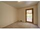 Spacious bedroom with carpet floors and door to the bright sun room at 1971 Kerr Gulch Rd, Evergreen, CO 80439