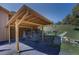 Carport detail featuring stone accents and lush green surroundings at 1971 Kerr Gulch Rd, Evergreen, CO 80439