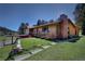 Charming exterior featuring a brick chimney and an inviting porch at 1971 Kerr Gulch Rd, Evergreen, CO 80439