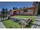 Charming home exterior featuring a cozy front porch with flower boxes and stone retaining wall at 1971 Kerr Gulch Rd, Evergreen, CO 80439