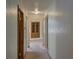 Hallway with neutral walls, white ceiling, and natural light from a distant window at 1971 Kerr Gulch Rd, Evergreen, CO 80439