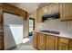 View of the kitchen featuring oak cabinets, a stove top, and natural light at 1971 Kerr Gulch Rd, Evergreen, CO 80439