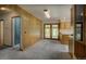 Open living room featuring wood-paneled walls and patio access at 1971 Kerr Gulch Rd, Evergreen, CO 80439