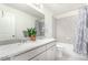 Bright bathroom with a double sink vanity, granite countertop, and a shower-tub combo at 803 N Bently St, Watkins, CO 80137