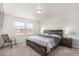 Comfortable bedroom with natural light, featuring a platform bed with wood accents and matching nightstands at 803 N Bently St, Watkins, CO 80137