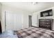Bright bedroom featuring closet and wall-mounted TV on top of dresser at 803 N Bently St, Watkins, CO 80137