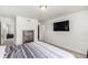 This bedroom features an inviting bed and a wall-mounted television for modern comfort at 803 N Bently St, Watkins, CO 80137