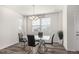 Contemporary dining room with a glass-top table, modern chairs, and wood-look floors at 803 N Bently St, Watkins, CO 80137